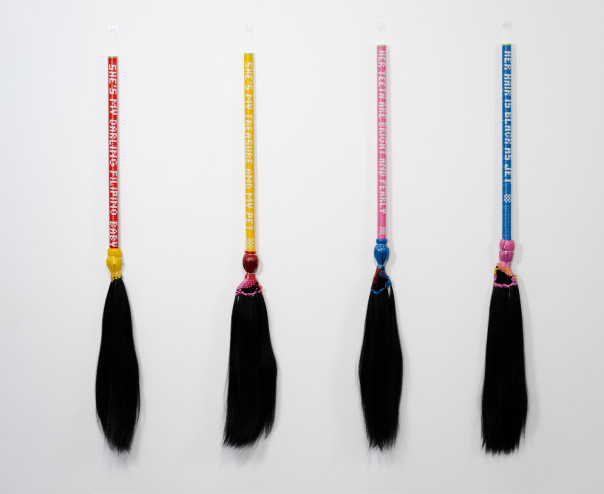 Thea Canlas ’06 (Fiber BFA), “My Filipino Baby #2,” 2025. Human hair, plastic rattan, and wood. Each broom 42 x 40 x 1 1/2 in.
