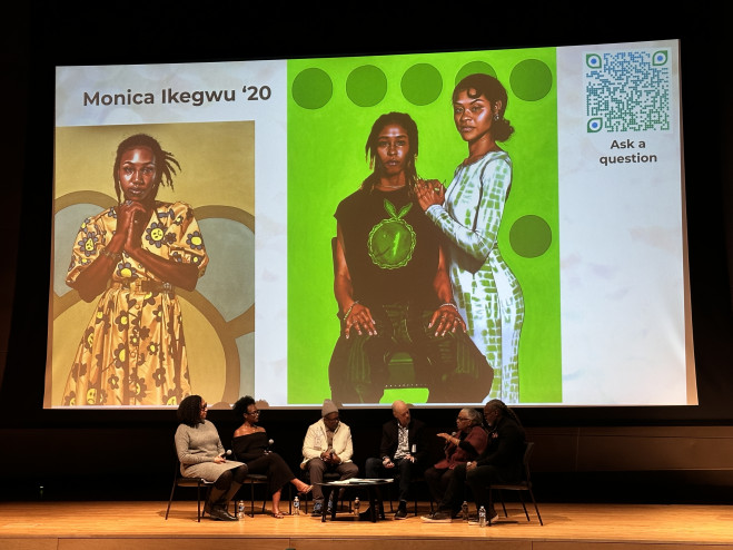 Panel sits in front of two large images of paintings by Monica Ikegwu '20